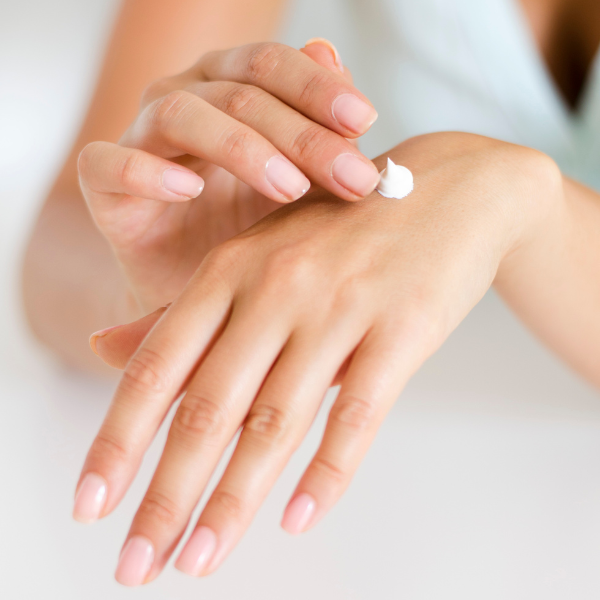 Woman putting lotion on hand